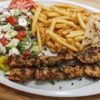 Chicken Souvlaki Wrap · Marinated chicken grilled in village olive oil dressing, placed on a warm fluffy pita with s...