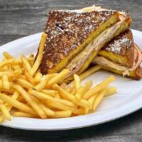 Monte Cristo Sandwich · Our Signature Challah French Toast Grilled with Sliced Turkey, Shaved Ham, and Swiss Cheese ...