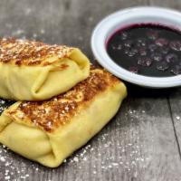 Cheese Blintzes · Crêpe filled with Sweet Homemade Cheese. Served with Blueberry Sauce and Sour Cream