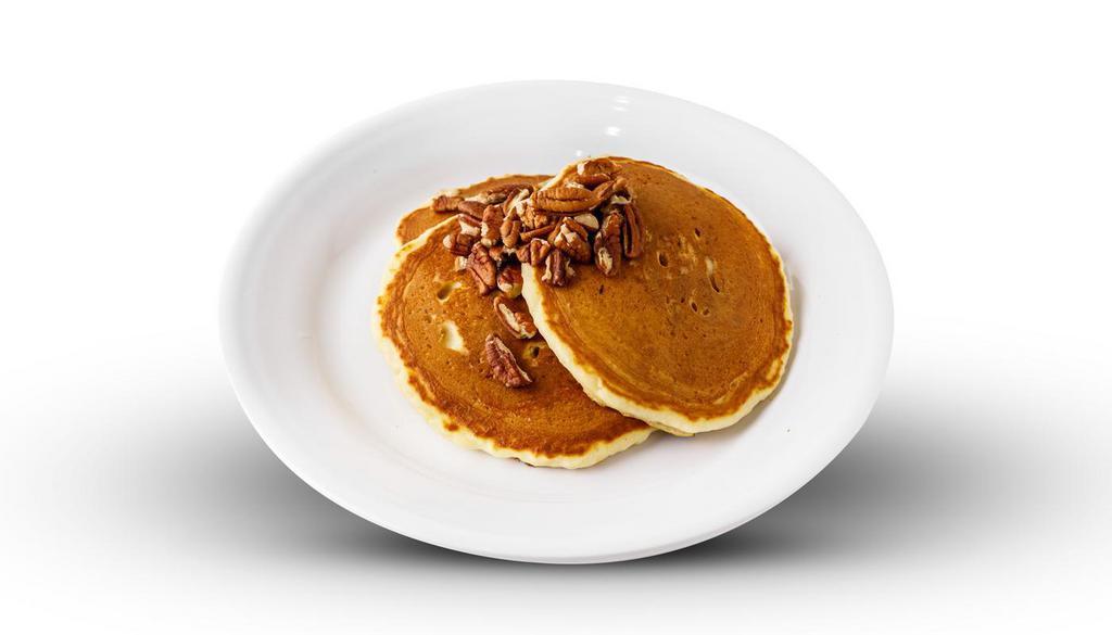 Pecan Pancakes · 6 buttermilk pancakes filled with pecans topped. with more pecans and powdered sugar.