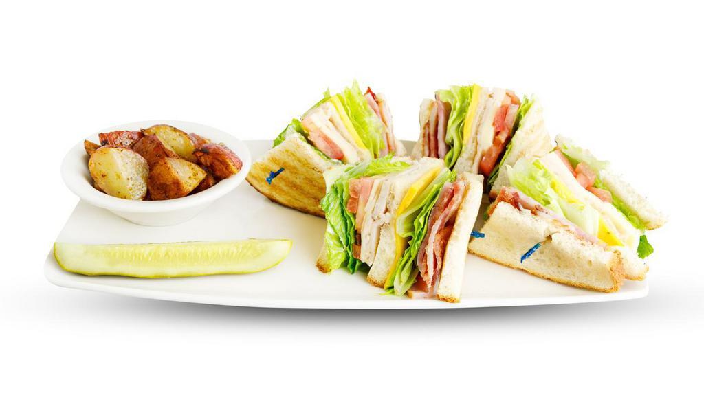Club Sandwich · Fresh turkey, ham, American and Swiss cheese piled high on your choice of toast with lettuce, tomato, thick sliced bacon and mayo. Served with a pickle spear and your choice of potatoes or fruit salad.