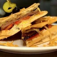 Pan Con Bistec · Our famous Grilled Steak sandwich, served in toasted Cuban bread with Grilled onions, lettuc...