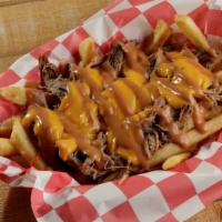 Semper Fries · Hero's portion of fries topped with braised beef, beer cheese, and smokehouse sauce.