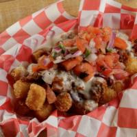 Tactical Tots · Hero's portion of tater tots with chili, pico de gallo, and queso cheese.