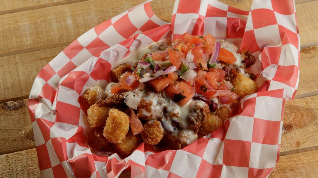 Tactical Tots · Hero's portion of tater tots with chili, pico de gallo, and queso cheese.