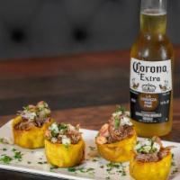 Tostones Rellenos De Vaca De Res · Fried green plantains topped with grilled shredded beef
