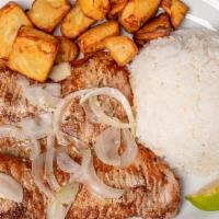 Bistec De Puerco A La Plancha · Grilled Pork Steak topped with cooked onions