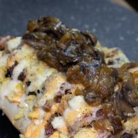 Guaro Especial · Grilled chicken, steak or both, over a crusty bread, bacon, caramelized onions, mushroom sau...