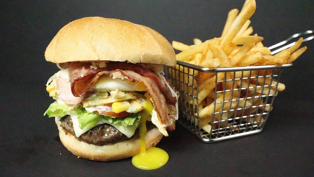 Latín Burger · Your choice of meat pbs styled, fried egg, potato sticks, lettuce, tomato, ham, white american cheese and fresh shredded cheese.