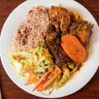 Brown Stew Chicken · Served with rice and peas or white rice and vegetables.