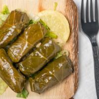 Dolmades · Grape leaves stuffed with rice, onions, dill, and herbs.