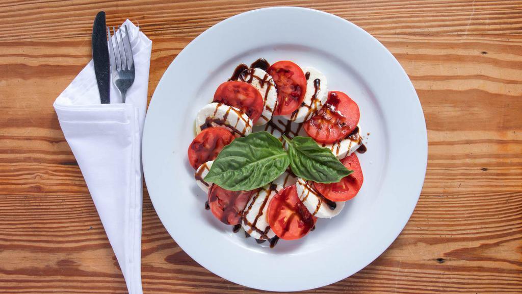 Caprese Mozzarella · Mozzarella fior di latte and sliced tomatoes topped with balsamic glaze and fresh basil.