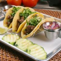Street Tacos · Served with cilantro, onions and tomatillo sauce.