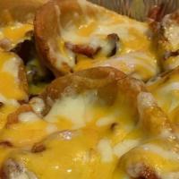 Potato Skins · Homemade topped with a Cheddar/Mozzarella blend, generous amount of Bacon served with a side...