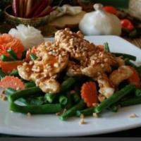 Chicken With Peanut Sauce · Sliced chicken simmered in a peanut sauce, and served over mixed vegetables.