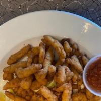 Fried Clam Strips · Battered seasoned and deep fried clams, served with Tartar sauce and lemon.