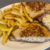 Reuben Sandwich · Sliced corned beef, sauerkraut, Swiss cheese and Thousand Island dressing on grilled rye wit...