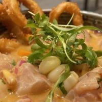 Carretillero Ceviche · Shrimp, octopus, corvina, cancha, choclo, onions in our carretillera leche de tigre; topped ...