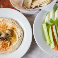 Hummus · Fresh homemade hummus with olive oil garlic and lemon juice and pita bread or veggie stick.