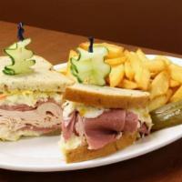 Turkey Reuben · Swiss cheese, sauerkraut, and Russian dressing. Served on rye bread. Served with a choice of...