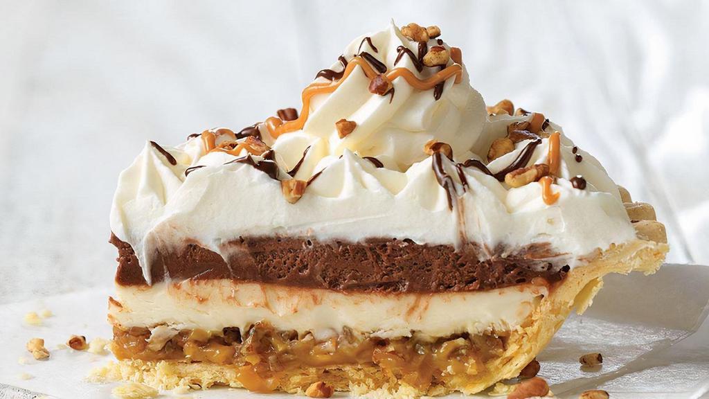 Caramel Pecan Silk Supreme Pie Slice · A rich and decadent pie featuring a layer of our classic French Silk, a creamy supreme filling, and a layer of caramel and Texas pecans. Topped with real whipped cream and drizzled with chocolate sauce, caramel and pecans.