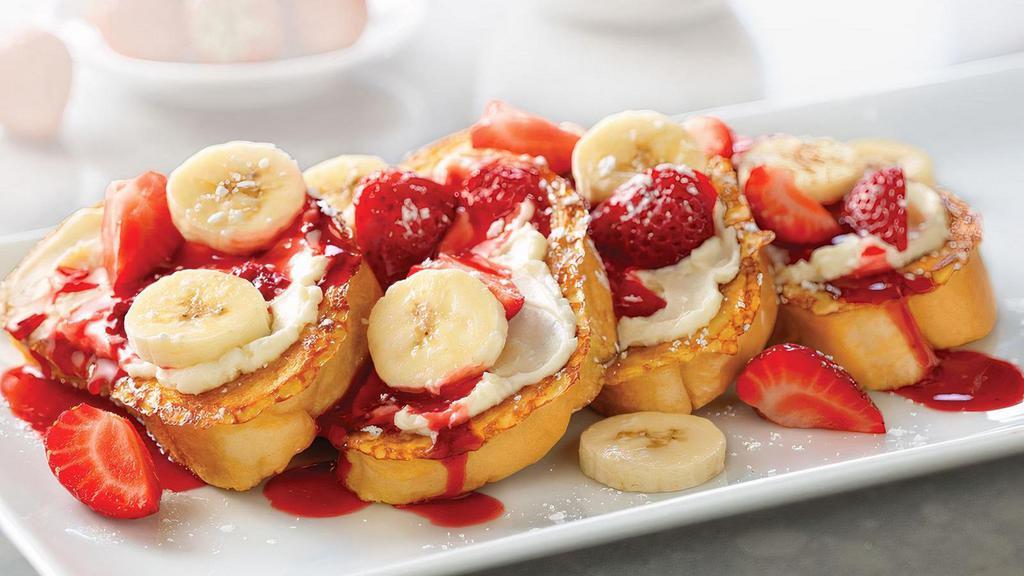 Strawberry-Banana Supreme French Toast · Four slices of vanilla-battered French toast topped with sweet supreme cream, fresh strawberries and sliced bananas.