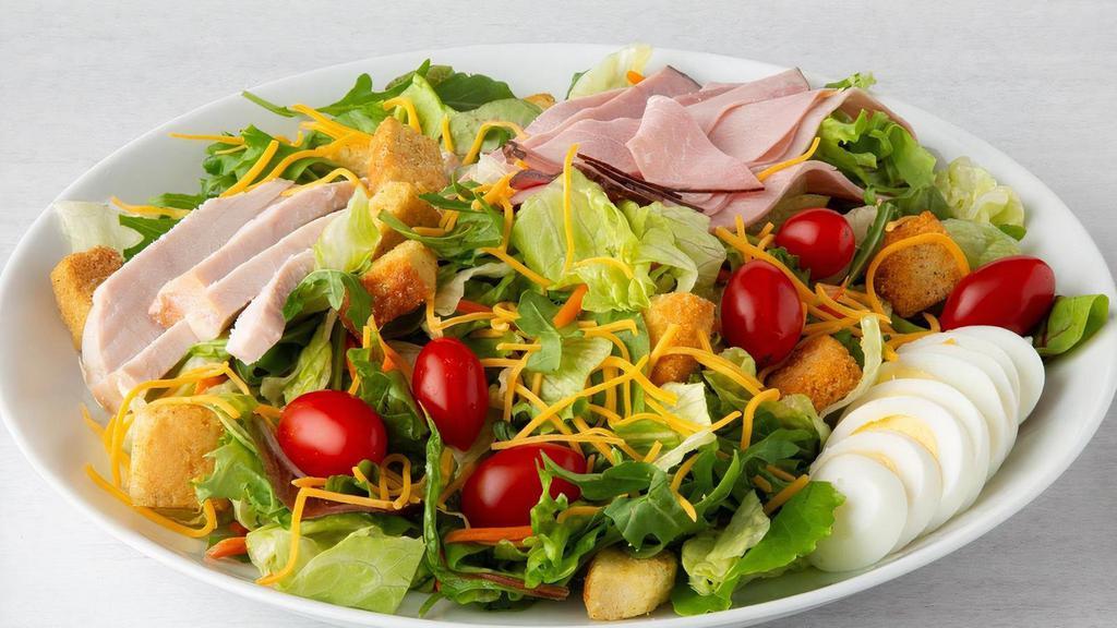Celebrity Chef Salad · Hand-carved turkey breast, ham, Cheddar cheese, tomato, hard-boiled egg and seasoned croutons on mixed greens..