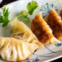 Gyozas · Steamed pork dumplings served with ginger soy sauce.