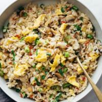 Fried Rice · Rice stir fried in wok with scrambled egg, onions, carrots and green peas.