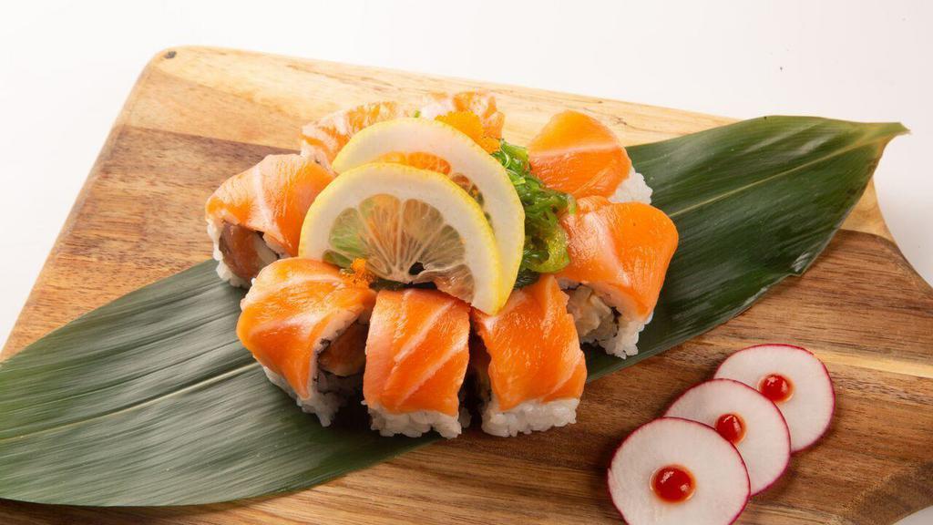 Orange Blossom Roll · Spicy salmon and cucumber topped with salmon, seaweed salad and masago.