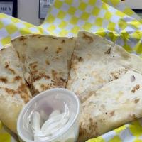 Quesadilla · Quesadilla filled with  onions, shredded cheese, tomato and sour cream