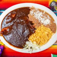 Pollo Con Mole · Chicken breast with mole, a sauce of mixed spices, dried peppers, peanuts and chocolate.