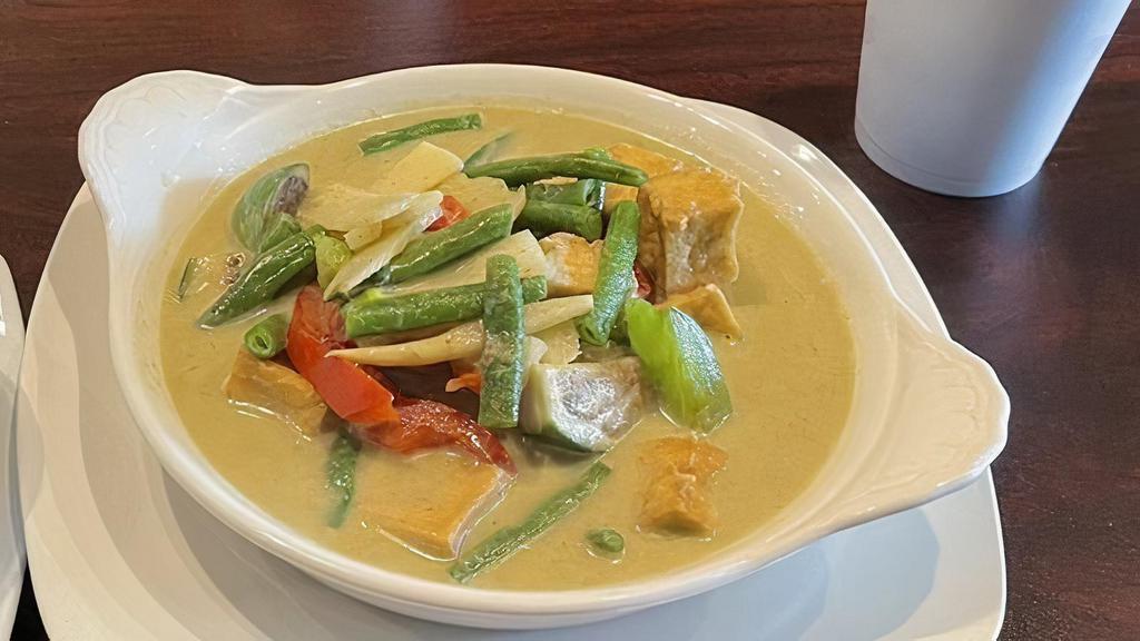 Green Curry   · Spicy. Green curry paste, Thai eggplant, basil, peas & green beans