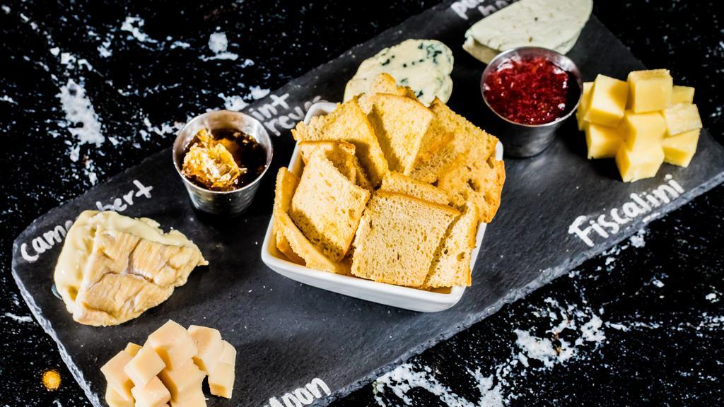 Artisanal Cheese Plate · Farmstead Cheeses and Seasonal Accompaniments.