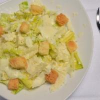 Classic Caesar Salad · Romaine Hearts, Parmigiano Reggiano, and Herbed Croutons.
