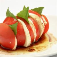 Tomato & Mozzarella · Local Heirloom Tomato, Basil, and Balsamic Reduction.