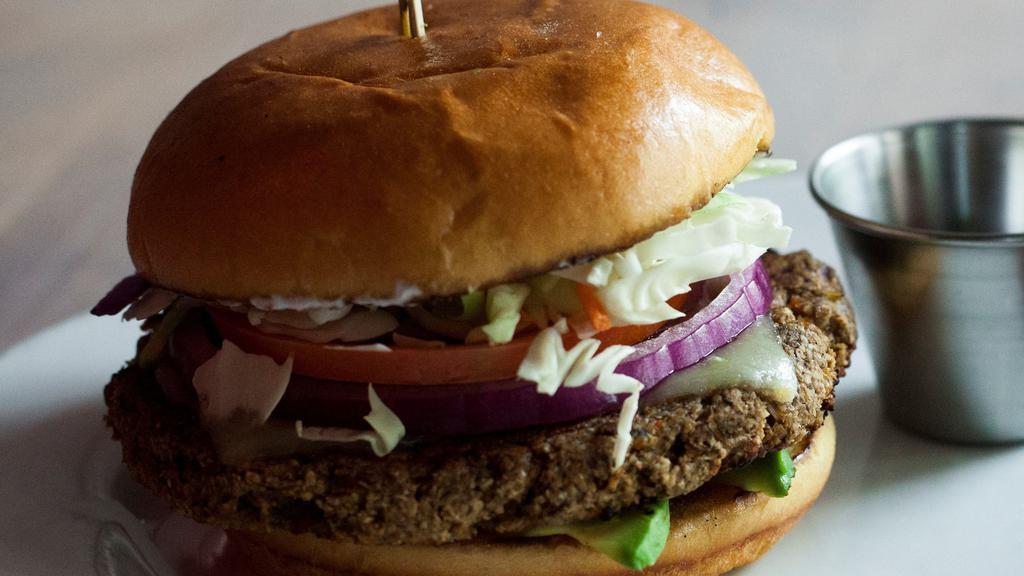 Black Bean Burger · Homemade black bean-mushroom patty topped with jack cheese, dry slaw, tomato, red onion, avocado and sour cream.