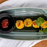 Kanom Jeeb/ Steamed Dumplings · Steamed chicken and shrimp dumplings, galangal, Thai chili, crispy garlic, soy chili sauce