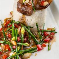 Moo Grob Kra Pow/ Pork Belly · Crispy pork belly, basil, garlic, chive blossoms, Thai chilies over jasmine rice