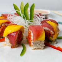 Fancy Tuna Roll · Spicy crunch tuna and avocado topped with pepper tuna, mango and sweet chili sauce.