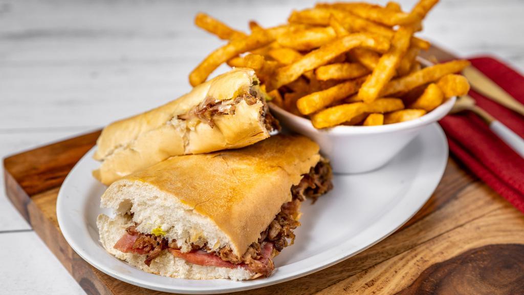 Cuban Sandwich · Ham, roasted pork, Swiss cheese, mustard & pickles make it a deluxe Cuban sandwich. Served with a side of fries.
