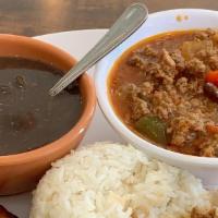 Picadillo · Ground beef simmered with olives, raisins, onions, & fresh red & green peppers. Served with ...