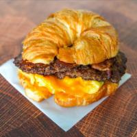 Croissant, Bacon, Sausage, Egg & Cheddar Sandwich · 2 scrambled eggs, melted Cheddar cheese, smoked bacon, breakfast sausage, and Sriracha aioli...