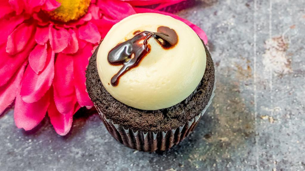 Lava Fudge · Chocolate cupcake with a vanilla cream cheese frosting and fudge filling.