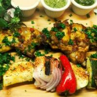 Chicken Kebab · 4 pcs chicken breasts pre-marinated over night, grilled to perfection, served with grilled v...