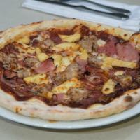 The Carnivore · Smoked ham, pepperoni, Italian sausage, sous-vide chicken, bbq-tomato base, mozzarella.