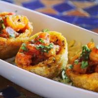 Tostones Rellenos De Camarones · Crispy Fried Green Plantain Cups Filled with Shrimp in a Creole Sauce with Pineapple and Cil...