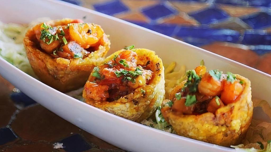 Tostones Rellenos De Camarones · Crispy Fried Green Plantain Cups Filled with Shrimp in a Creole Sauce with Pineapple and Cilantro