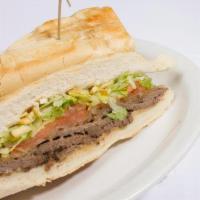 Pan Con Bistec · Steak Sandwich with Grilled Onions, Shoestring Potatoes, Lettuce, Tomato and Our Special Sauce