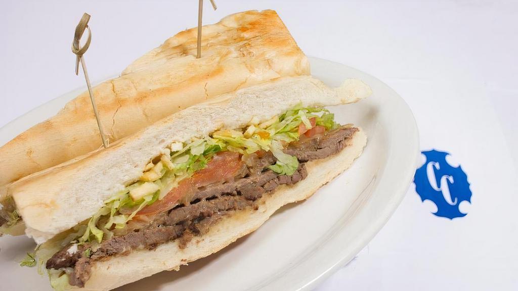 Pan Con Bistec · Steak Sandwich with Grilled Onions, Shoestring Potatoes, Lettuce, Tomato and Our Special Sauce